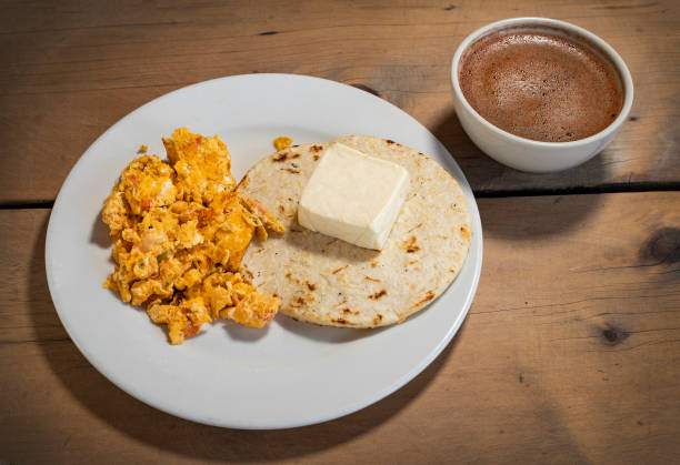 Arepa with cheese, egg and hot chocolate - Traditional Colombian breakfast