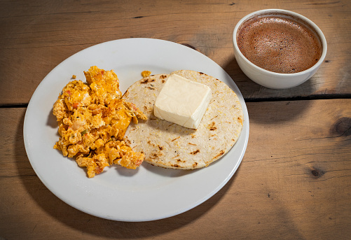 Traditional Colombian breakfast - Arepa with cheese, egg and hot chocolate