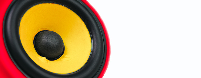 Yellow loudspeaker in red speaker cabinets isolated on white background with copy space.