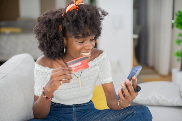 istock Cheerful  woman doing online shopping 1481787471