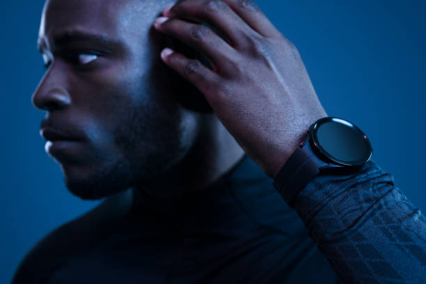 istock Crop black man adjusting headphones in blue studio 1481789289