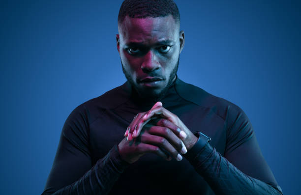 Serious black sportsman in neon light