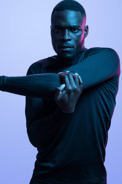 istock Motivated black sportsman stretching triceps during workout 1481789379