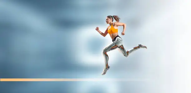 Photo of Female cyborg with bionic legs running on tech background