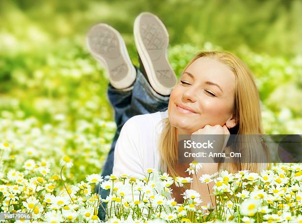 A Woman Laying In A Field Of Wild Flowers Stock Photo - Download Image Now - Active Lifestyle, Adult, Agricultural Field