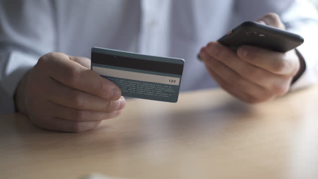 Man makes purchases by phone using credit card