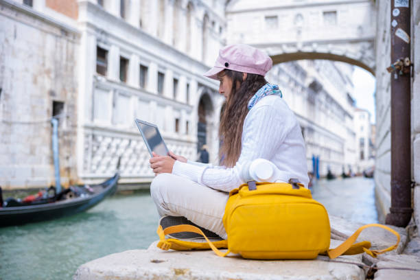 istock Woman works on laptop while on vacation in Venice. 1481795196