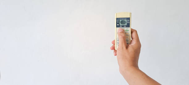 istock Man's Hand holding air conditioner 1481810903