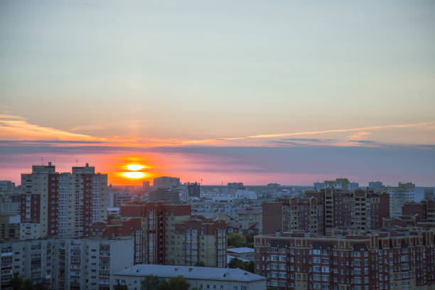 istock Sunset breaks through clouds and illuminates residential area 1481814557
