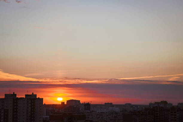 istock Sun sets down and illuminates evening city with last rays 1481814601