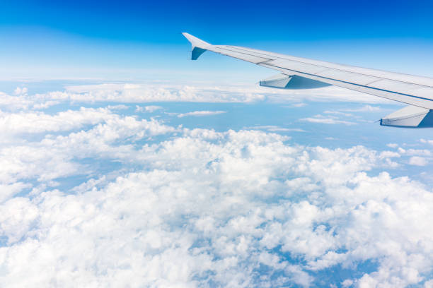 istock View from the airplane window at a beautiful cloudy sky and the airplane wing 1481816569