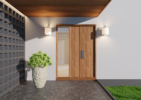 The entrance to the new house with a large wooden door. On the sides there are gray vent walls and trees. 3D rendering.