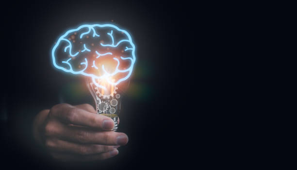 istock idea and creativity concept. man holding light bulb with virtual brain and gear icons, idea, innovation and inspiration concept 1481818480