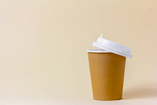istock A paper cup for takeaway coffee on a light beige background. 1481819129