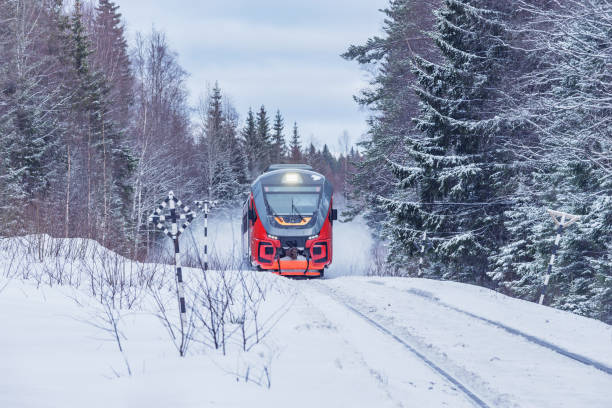 Passenger train moves fast at winter day.