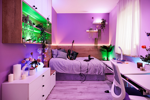 Modern, generation z girl room. Lot of led lights, white furniture and purple walls.\nCanon R5