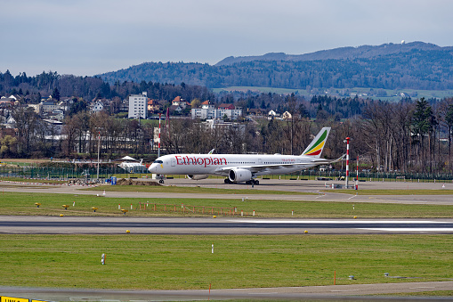 Side view of Ethiopian Airlines Airbus A350-941 register ET-AWM parked at Zürich Airport on a blue cloudy winter day. Photo taken March 17th, 2023, Zurich, Kloten, Switzerland.