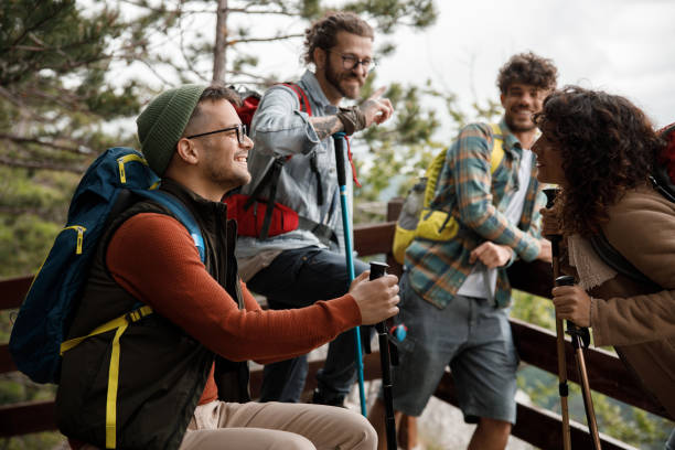 istock Happy hikers talking on a break at mountain. 1481828809