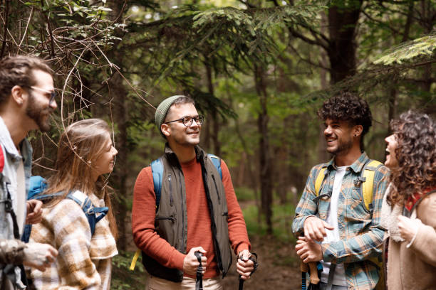 istock Young happy hikers talking on a break in forest. 1481828975