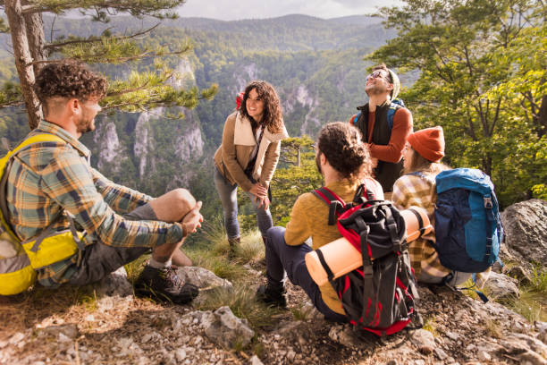 istock Happy backpackers talking on a break at rocky mountain. 1481829062