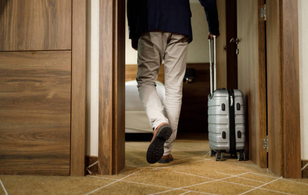 istock Rear view of unrecognizable man leaving for a journey with a suitcase. 1481829775