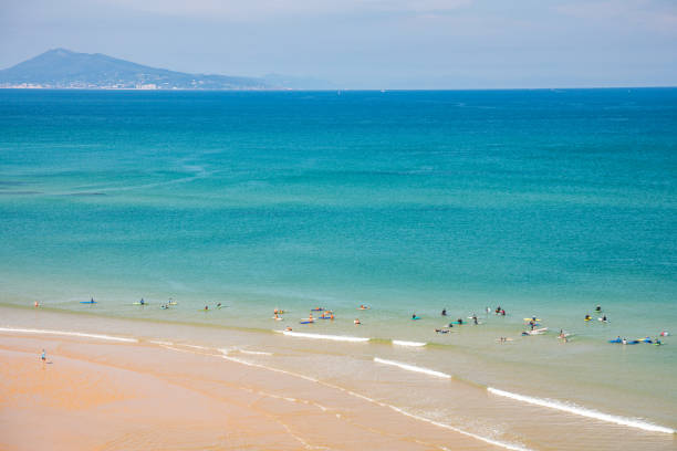 Surfers in the ocean at Cote des Basques beach in Biarritz