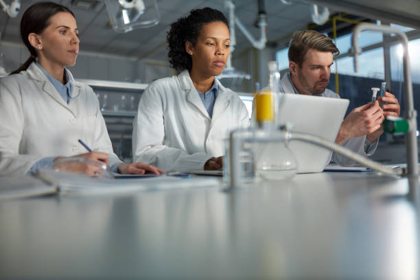 istock Students of science working on laptop in laboratory. 1481829981