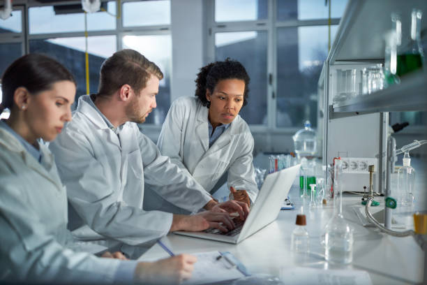 istock Young students of chemistry working on laptop in laboratory. 1481830905