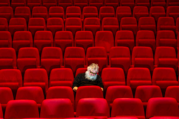 istock Concept boredom:One man  sits in Empty cinema or theatre, sleeping 1481831161