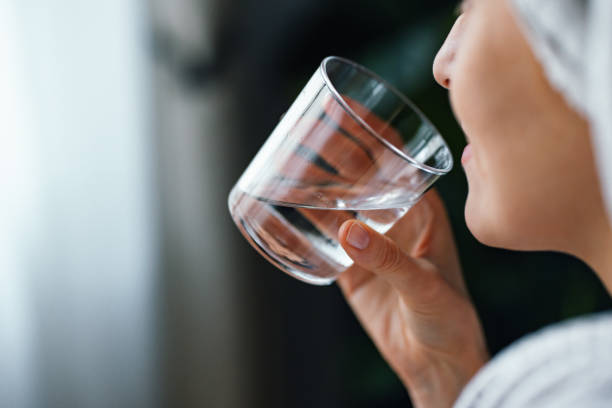 istock Anonymous Woman Drinking a Glass of Water 1481832841