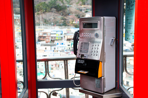 Old public telephone for local korean people travelers use service call phone at outdoor of building a tGamcheon Culture Village or Santorini of Pusan city on February 18, 2023 in Busan, South Korea
