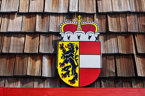 Coat of arms of the land of Salzburg Austria. Coat of arms of Salzburg on a wooden wall.
