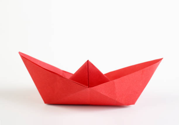 istock Red origami boat on white background 1481834322