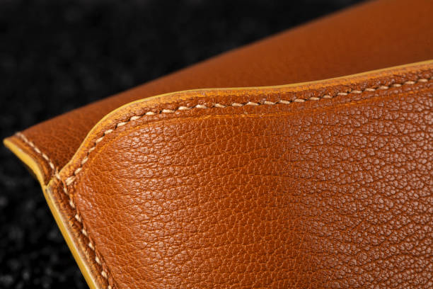 istock Part of a brown leather wallet or case with stitching. 1481835207