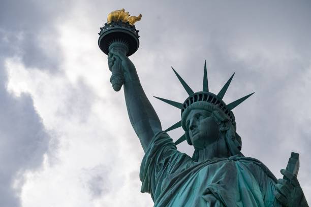 istock Majestic Statue of Liberty illuminated against a cloudy sky. 1481836684