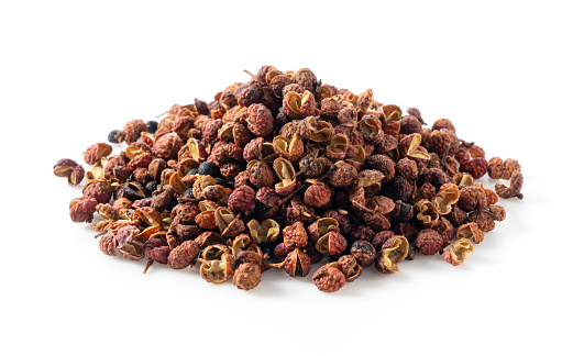 Sichuan pepper placed on a white background. Sichuan pepper is a member of the sansho family used in Chinese cuisine.