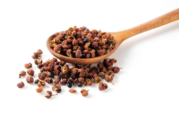 istock Sichuan pepper and wooden spoon set against a white background. 1481837421