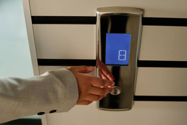istock Businesswoman pushing button of elevator 1481837733
