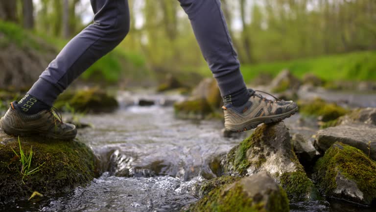 SLO MO Close-up of feet crossing a stream