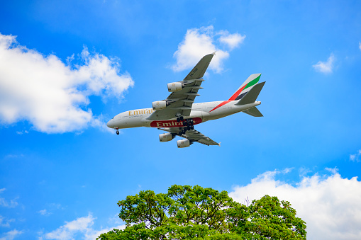 Airbus A380-800 airplane of Emirates, the largest airline operator of the largest passenger airliner. The Airbus A380 is the world's largest passenger airliner and the only full length double deck airplane. The landing gear is out as the plane flies at low altitude.