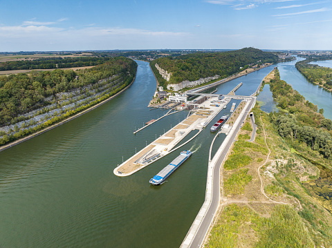 Freight ships in the Lanaye locks where the Albert Canal connects to the river Meuse close to Liege and Maastricht. Drone point of view.