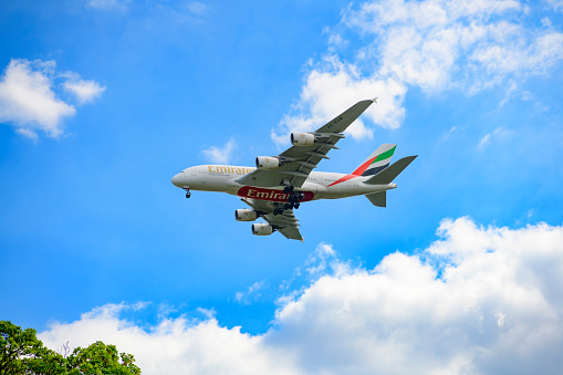 Airbus A380-800 airplane of Emirates, the largest airline operator of the largest passenger airliner. The Airbus A380 is the world's largest passenger airliner and the only full length double deck airplane. The landing gear is out as the plane flies at low altitude.