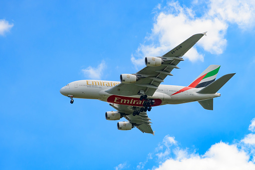 Airbus A380-800 airplane of Emirates, the largest airline operator of the largest passenger airliner. The Airbus A380 is the world's largest passenger airliner and the only full length double deck airplane. The landing gear is out as the plane flies at low altitude.