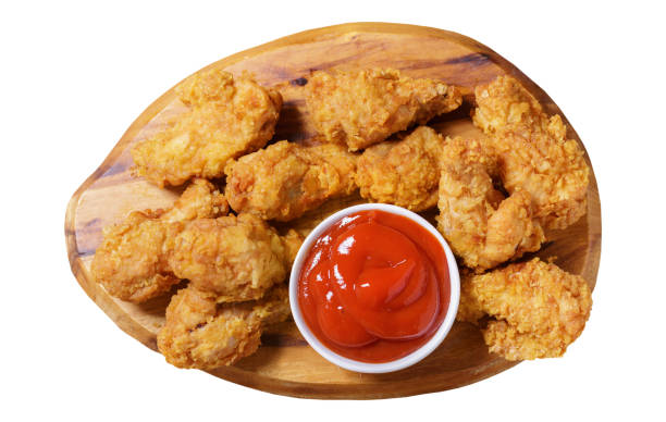 istock fried chicken with ketchup on a wooden board isolated on white background 1481843632