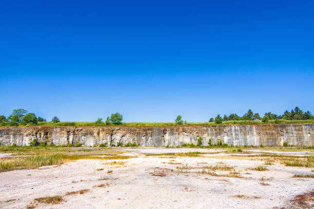 istock Old abandoned quarry with a rock face 1481844622