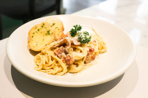 istock bacon spaghetti, spaghetti carbonara or pasta or pasta carbonara and garlic bread 1481844897