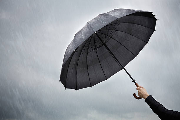 istock Person holding an open umbrella in the rain 148184490
