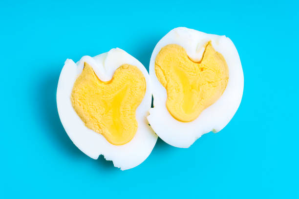 istock Heart-Shaped Boiled Egg Cut in Half Isolated on Blue 1481845240
