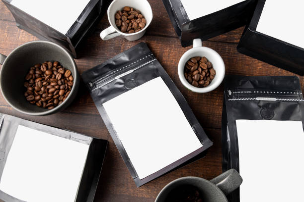 istock Black coffee foil packaging bag with blank white label on wooden table 1481846167