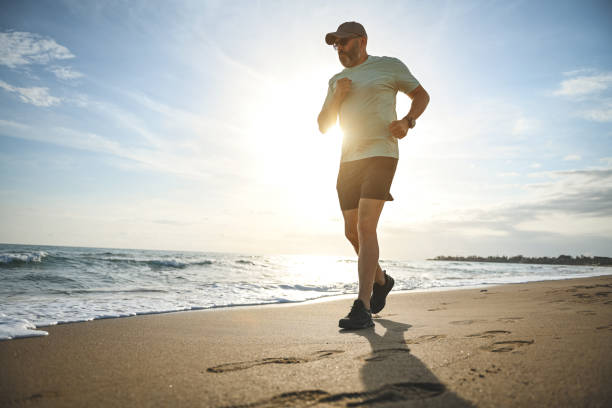 istock man walking and doing sports on the beach 1481846214